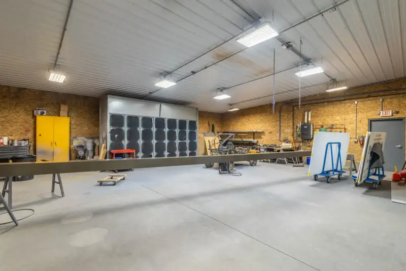 Fabrication shop floor where sign structures are welded and assembled