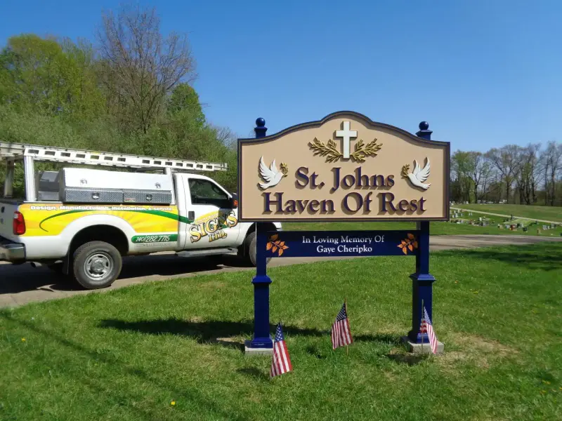 Post and panel memorial sign at St. Johns Haven of Rest with a Signs Limited service truck