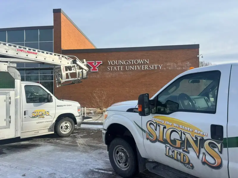 Signs Limited trucks at a Youngstown State University exterior sign project